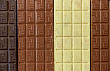 糖果,糖果食品牛奶,黑白巧克力棒纹理背景棕色背景下同种类的巧克力背景