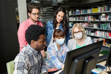健康教育大流行群快乐微笑的国际学生戴着保护医学面具,学校图书馆用电脑保护免受病感染学生戴着医用口罩,图书背景图片