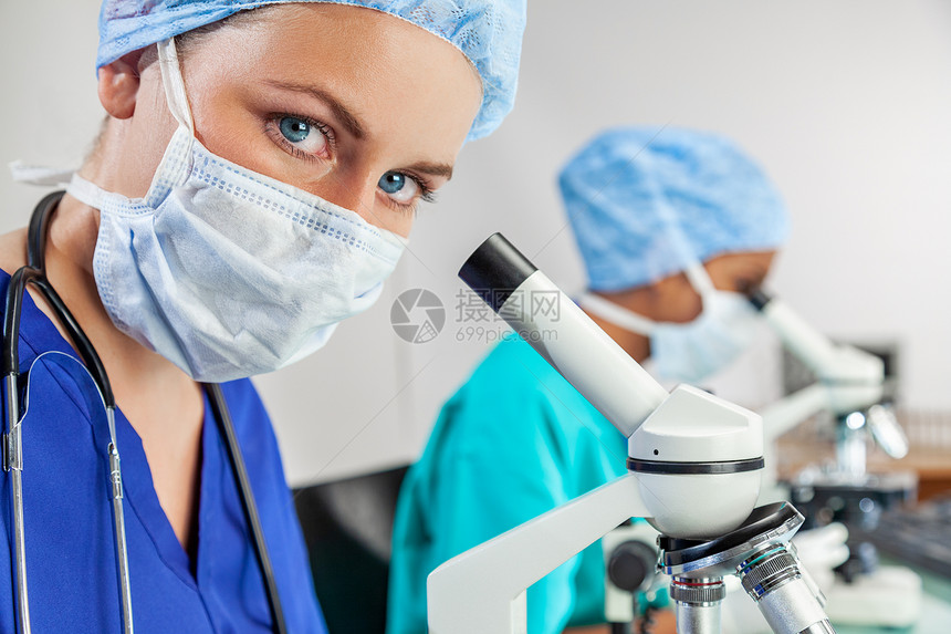 与同事起研究实验室或实验室用显微镜的女医学或科学家图片