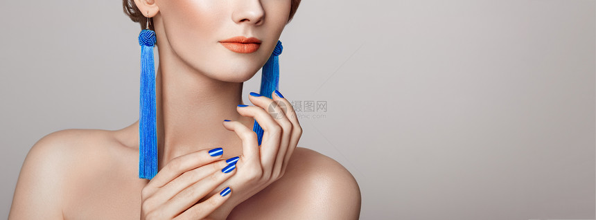 美丽的女人,大耳环,流苏,珠宝,蓝色完美的化妆指甲修剪图片