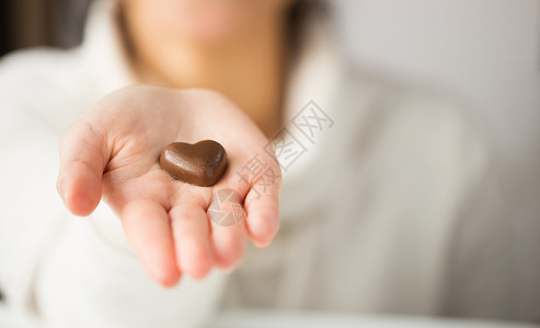 情人节,糖果糖果的近距离的手心形巧克力糖果用心形巧克力糖果靠近手图片