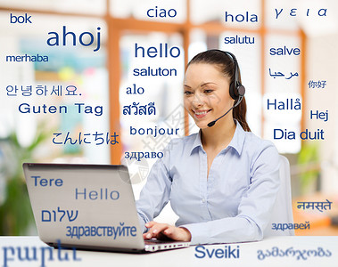 翻译,商业技术微笑的女翻译操作员与电脑办公室用同的外语问候词笔记本电脑的女人超过了外语的单词词典高清图片素材