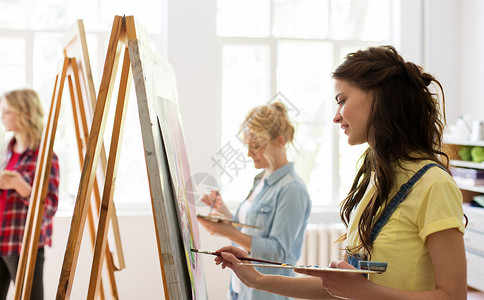艺术学校,创造力人的妇女与画架,调色板画笔工作室艺术学校工作室画画画架的女人爱好高清图片素材