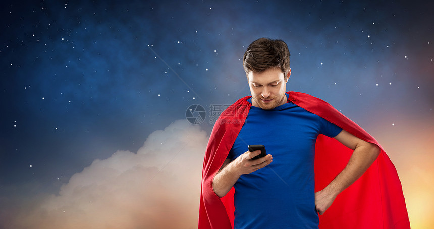 超级力量,技术人的轻人红色超级英雄斗篷用智能手机星空背景穿着红色超级英雄斗篷的轻人用智能手机图片
