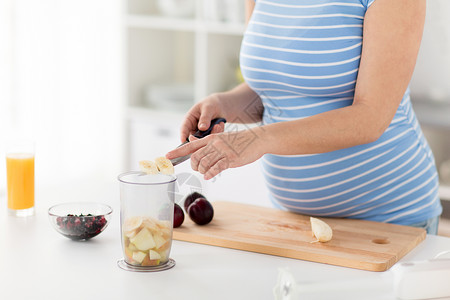 烹饪怀孕健康饮食孕妇家里用菜刀切水果图片