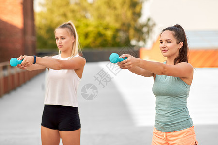 健身,运动健康的生活方式轻妇女女朋友锻炼与哑铃户外女人户外用哑铃锻炼图片