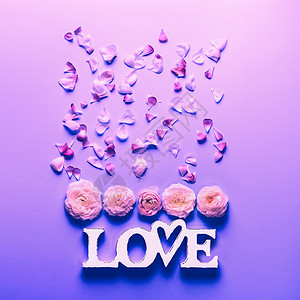 霓虹灯颜色背景上的花朵文字爱情节日花卉,顶部视图平躺构图图片