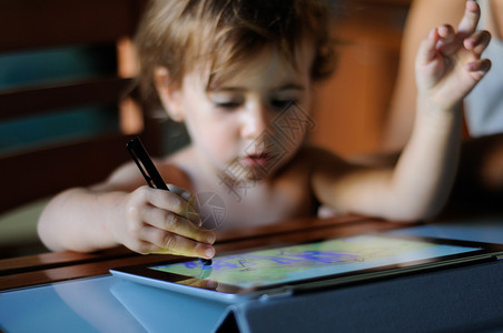 小女孩家用数字平板电脑画画小女孩,两岁,家用数字平板电脑画画图片