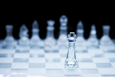 国际象棋国王站另种颜色前的照片,背景明亮成功高清图片素材