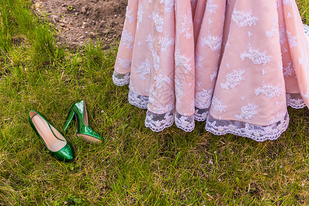 婚礼翡翠伴娘鞋绿草上的背景上的裙子图片