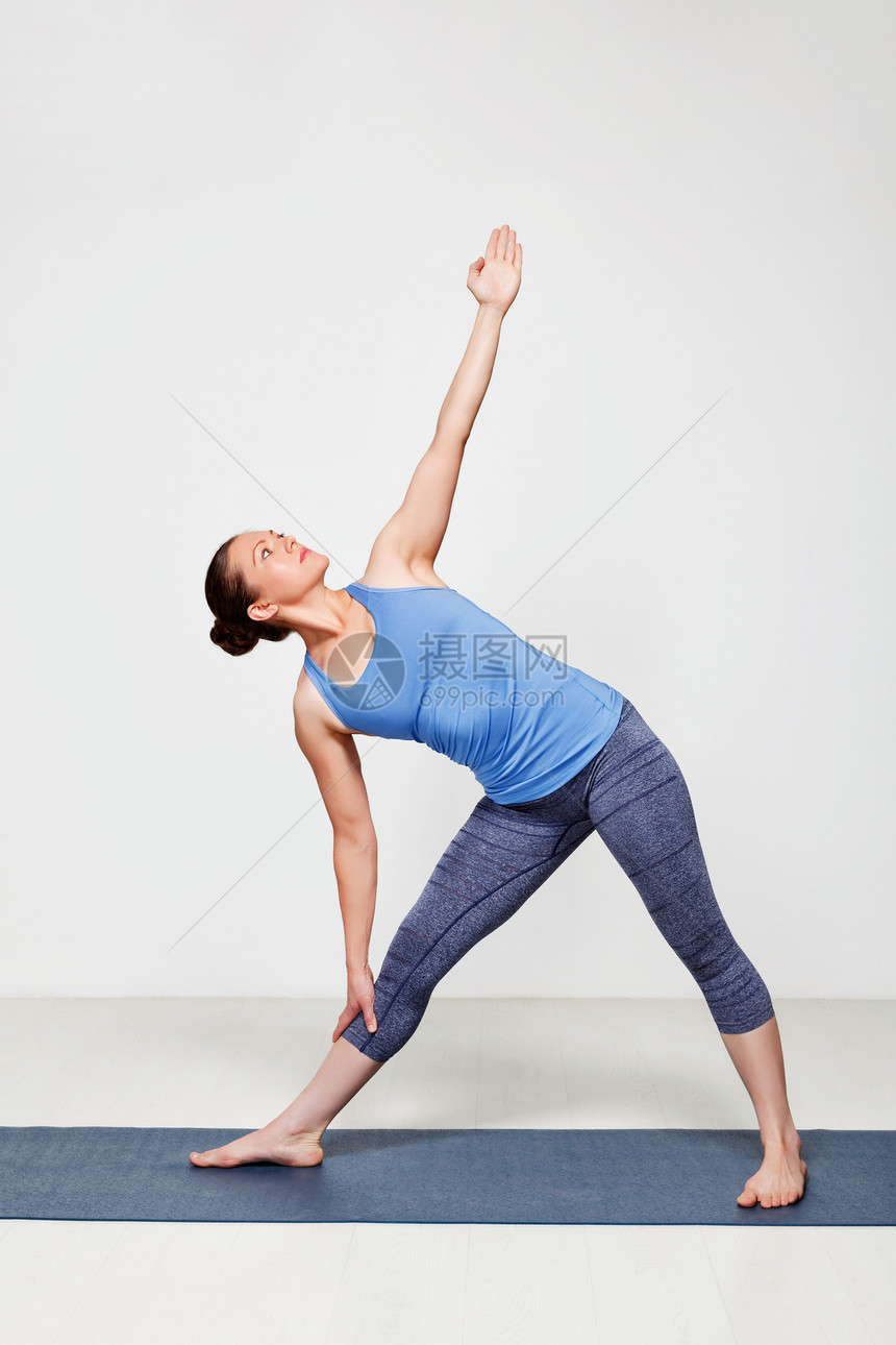 美丽的运动适合女练瑜伽阿萨纳utthitaTrikonasana扩展三角形姿势初学者变化瑜伽的女人阿莎娜乌蒂塔特图片