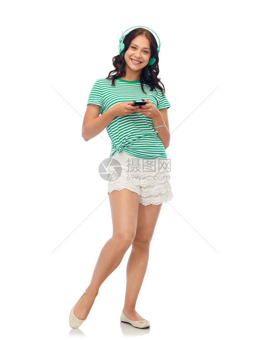 音乐,技术人的快乐的少女耳机与智能手机戴着智能手机耳机的快乐少女图片