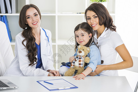 儿科医生办公室的母亲孩子快乐的母亲孩子与泰迪熊听诊器儿科医生办公室图片