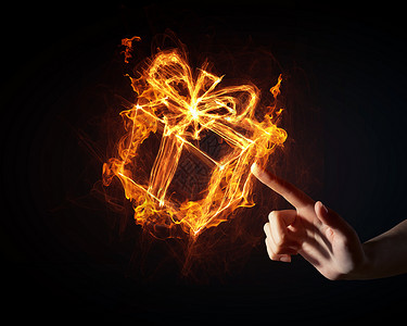 礼品盒图标发光的火礼盒图标黑暗的背景图片