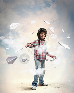 飞行员头盔里的小男孩的形象,背景纸飞机图片