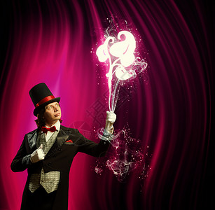 戴帽子的魔术师男子魔术师的形象,魔术与颜色背景高清图片