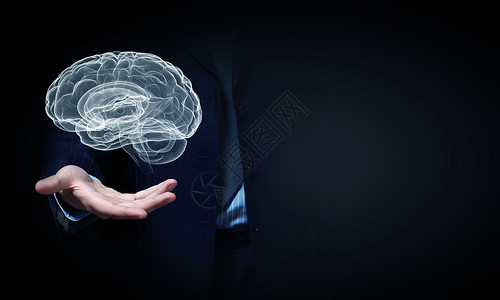 媒体大脑人类的大脑靠近商人的手,把大脑握掌心背景