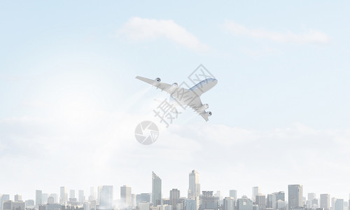 飞机空中飞行客机飞越现代城市景观图片