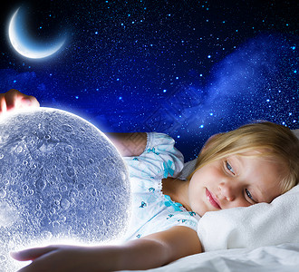 晚安女孩躺床上,手里着月亮可爱的高清图片素材