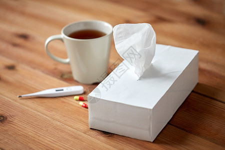 医疗保健,医学,流感治疗杯茶,纸巾温度计与药丸背景图片