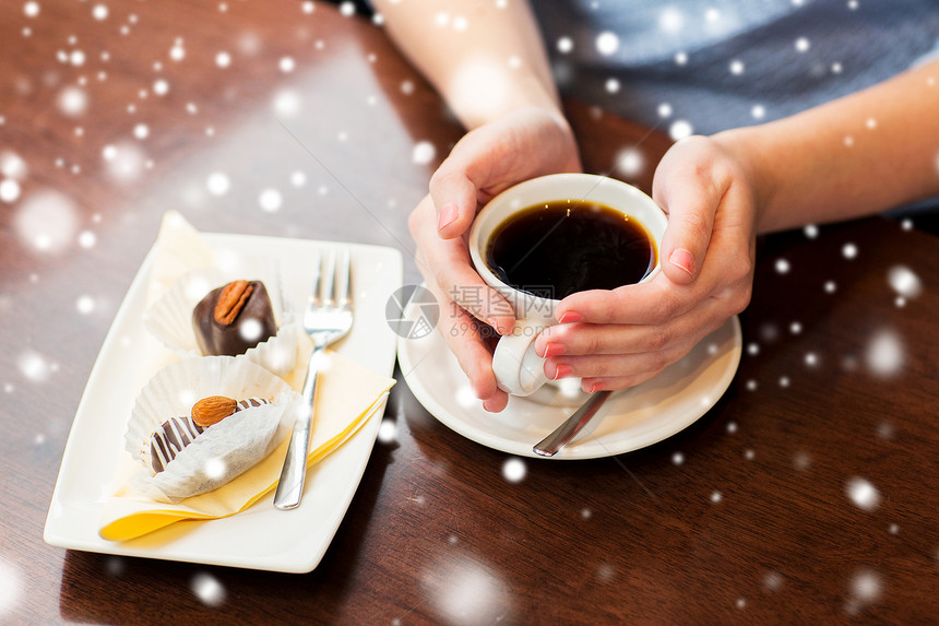 饮料,人生活方式的近距离的女人手杯子与热黑咖啡甜点雪地上图片