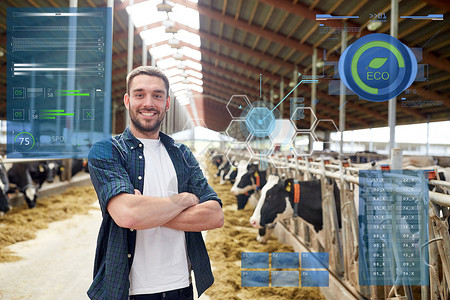 农业,人畜牧业的快乐的微笑轻人农民与牛群奶牛场的牛棚奶牛场的牛舍里养牛的人农民背景图片