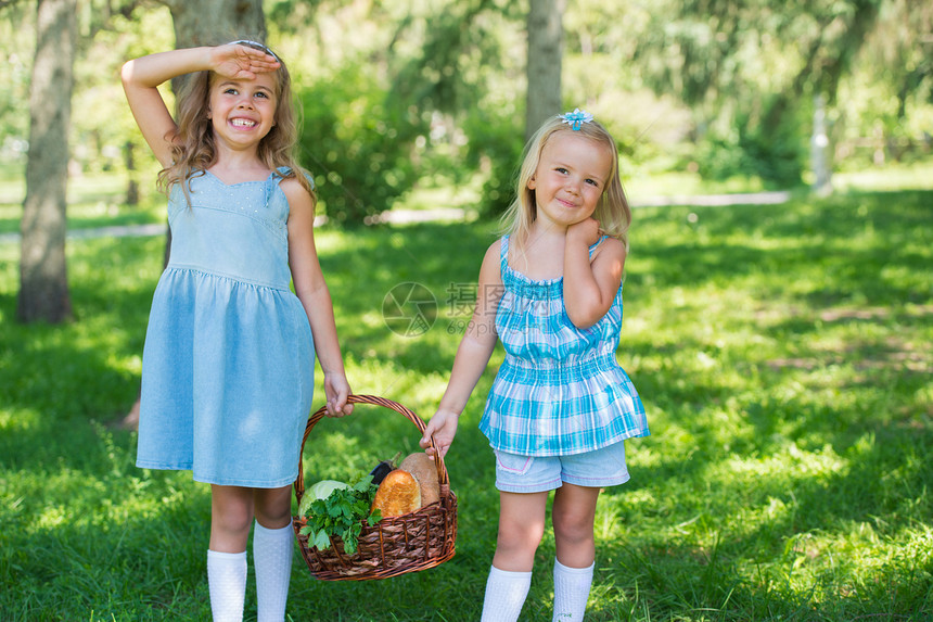 两个小女孩着篮子机食物野餐,户外图片