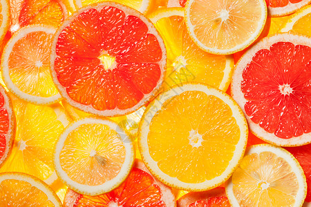 彩色柑橘类水果柠檬,橘子,柚子片背景背光背景图片