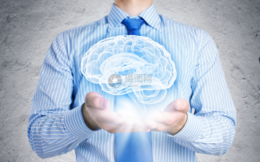 医学创新特写商人手中握着大脑的形象图片
