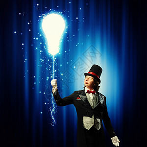 戴帽子的魔术师男子魔术师的形象,魔术与颜色背景图片