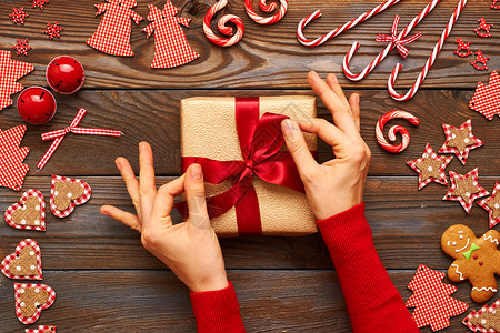 女手诞礼物自制姜饼饼干与手工装饰木制背景图片
