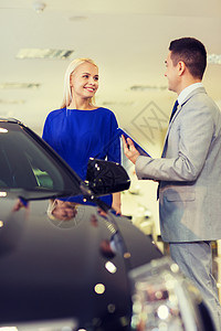 汽车业务,汽车销售,消费主义人的快乐的女人与汽车经销商车展沙龙图片