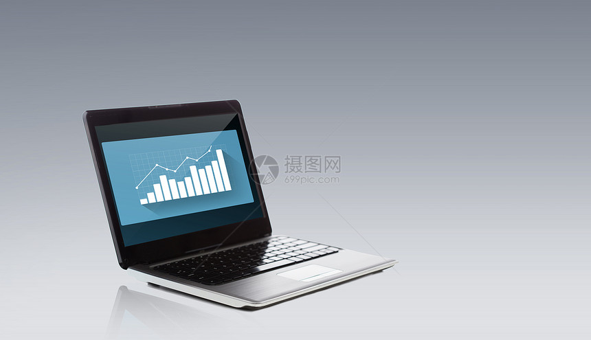 技术,商业,统计成功笔记本电脑屏幕上的图表灰色背景图片
