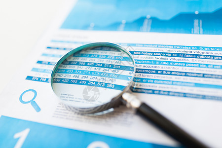 商业统计经济金融研究理念财务报告文件放大镜的特写图片