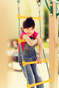 夏天,童,休闲人的快乐的小女孩儿童游乐场爬绳梯图片