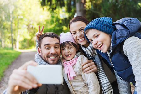 技术,旅游,徒步旅行人们的快乐的家庭与背包自拍智能手机徒步旅行图片