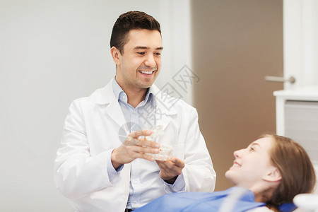 人,医学,口腔科保健快乐的男牙医下巴布局给病人女孩牙科诊所办公室图片