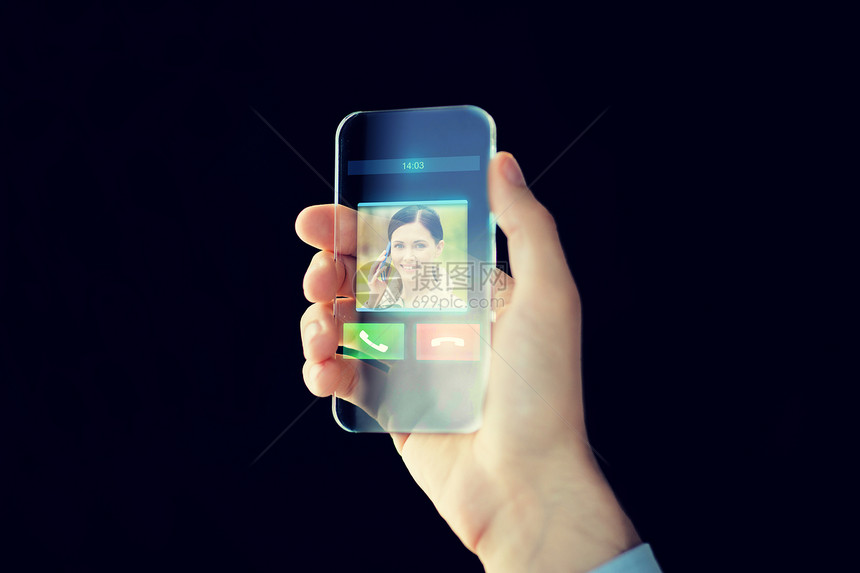 商业,未来技术,通信人的男手握透明智能手机与传入视频呼叫图标屏幕上的黑色背景图片
