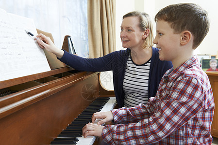 音乐老师上钢琴课的男孩图片