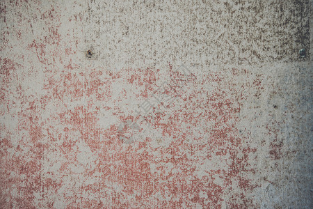 用撕裂的红色油漆装饰混凝土墙的背景图片
