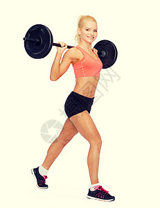 健身,运动运动微笑的运动妇女与杠铃分裂蹲弓步高清图片
