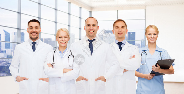 医学,专业,队合作医疗保健微笑的医生医生与剪贴板听诊器临床背景图片