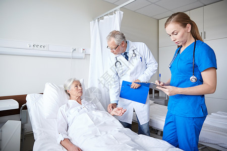 医学,龄,保健人的医生护士与剪贴板访问老病人妇女检查她的脉搏医院病房图片