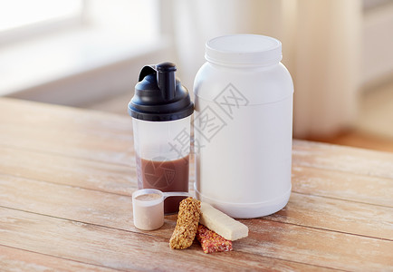 运动,健身,饮食食物罐子,蛋白质瓶木桌上的木条背景图片