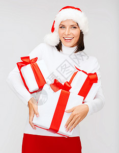 很多礼物诞节,冬天,幸福的微笑的女人戴着诞老人的帽子,很多礼品盒背景