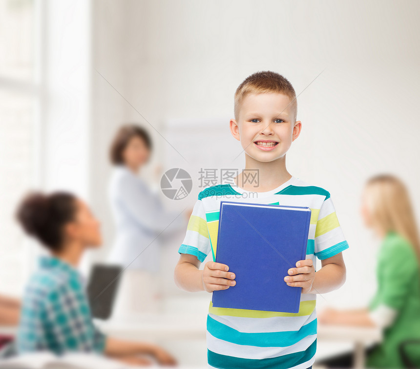 教育,童,队合作学校理念微笑的小学生男孩与蓝色的书超过群学生课堂上图片