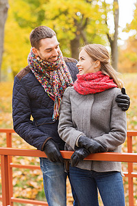 爱关系家庭季节人的微笑的情侣秋园的桥上拥抱图片
