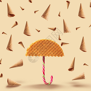 用华夫饼华夫饼的伞,黄色背景上雨锥华夫饼焦糖高清图片
