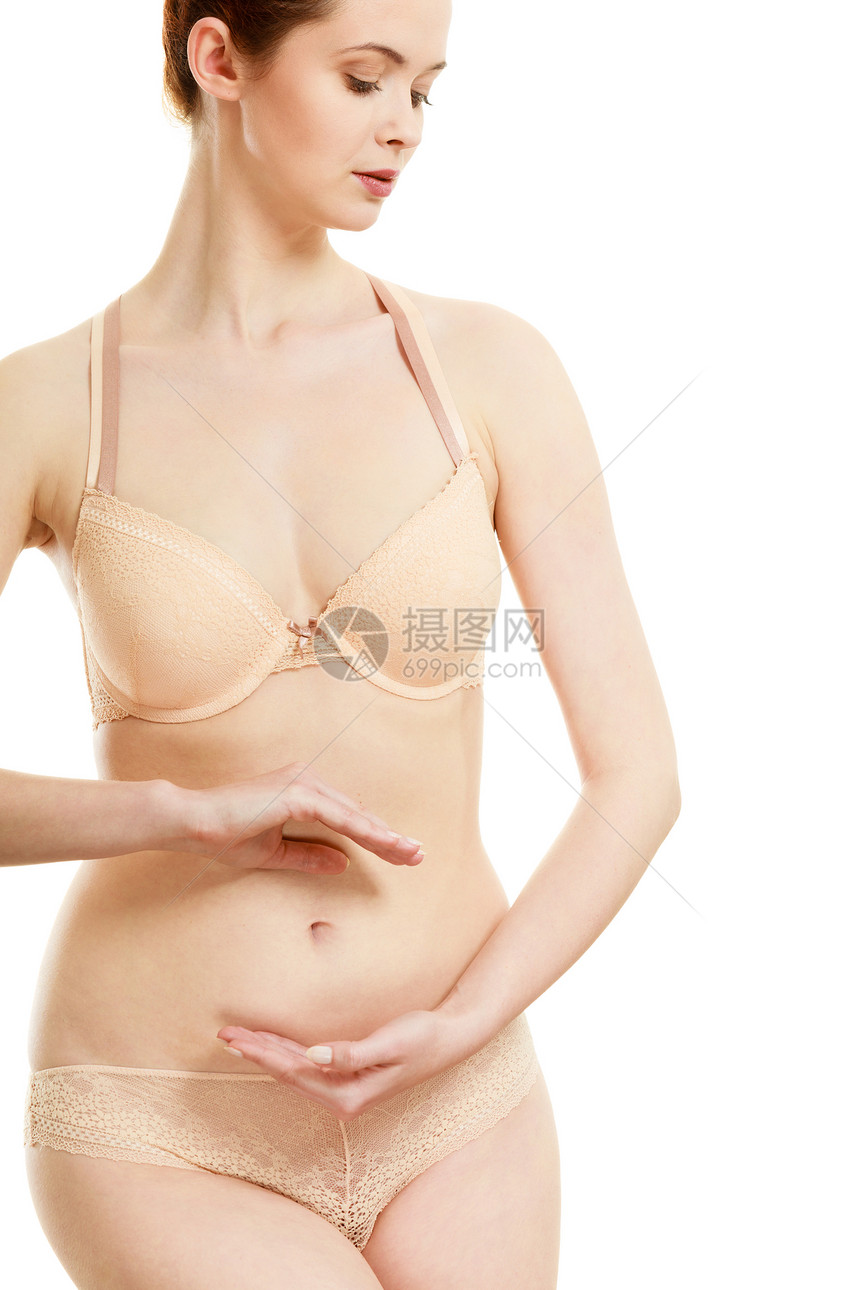 身体护理怀孕女人她的腹部创造符号女的手光滑的气孔上白色上隔离女人她的腹部创造符号图片