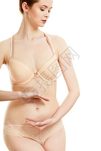 身体护理怀孕女人她的腹部创造符号女的手光滑的气孔上白色上隔离女人她的腹部创造符号背景图片